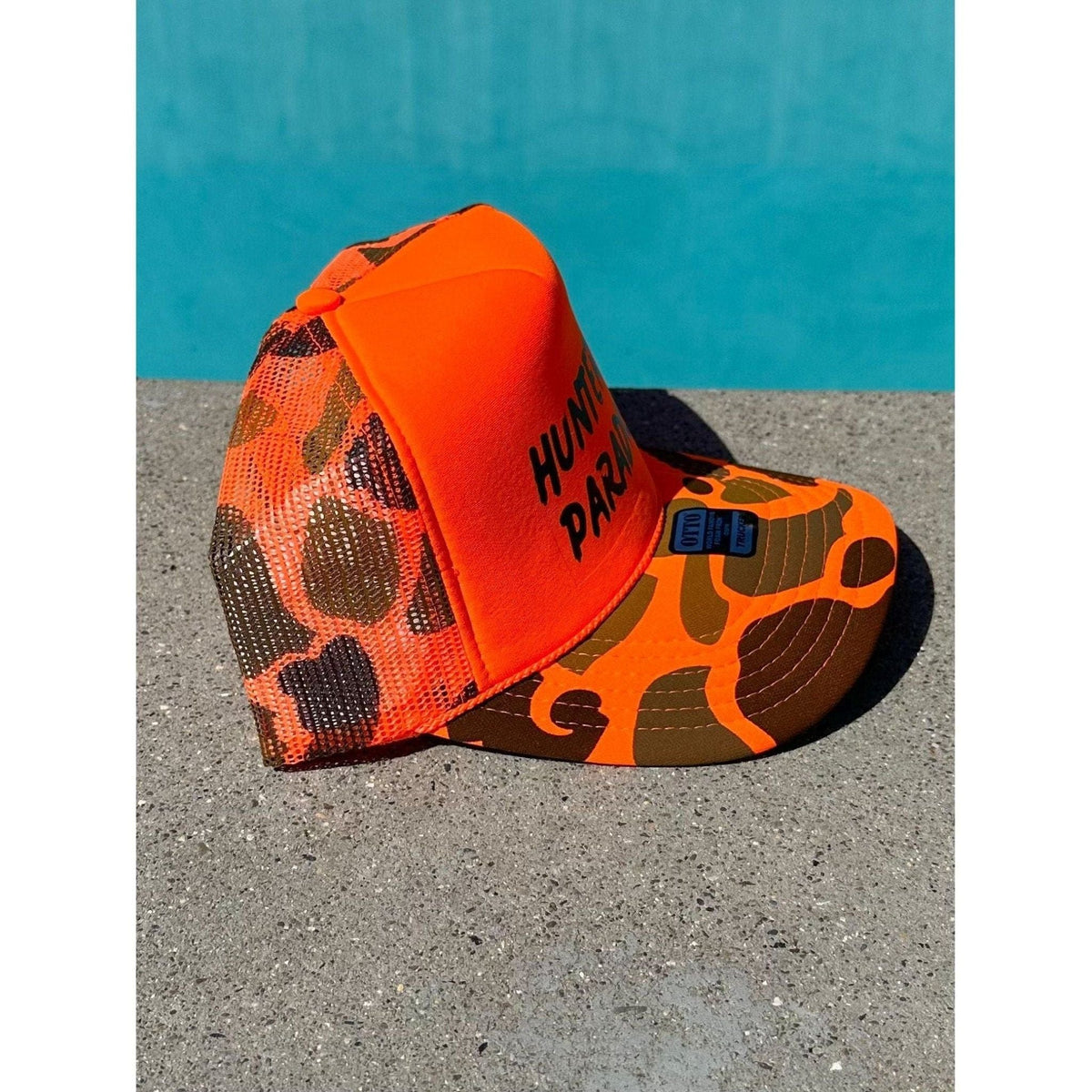 Hunters Paradise | Orange Camo Trucker Hat by Haute Sheet Hats TheFringeCultureCollective